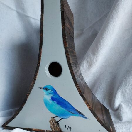 Birdhouse with a blue Mountain bluebird painted on it