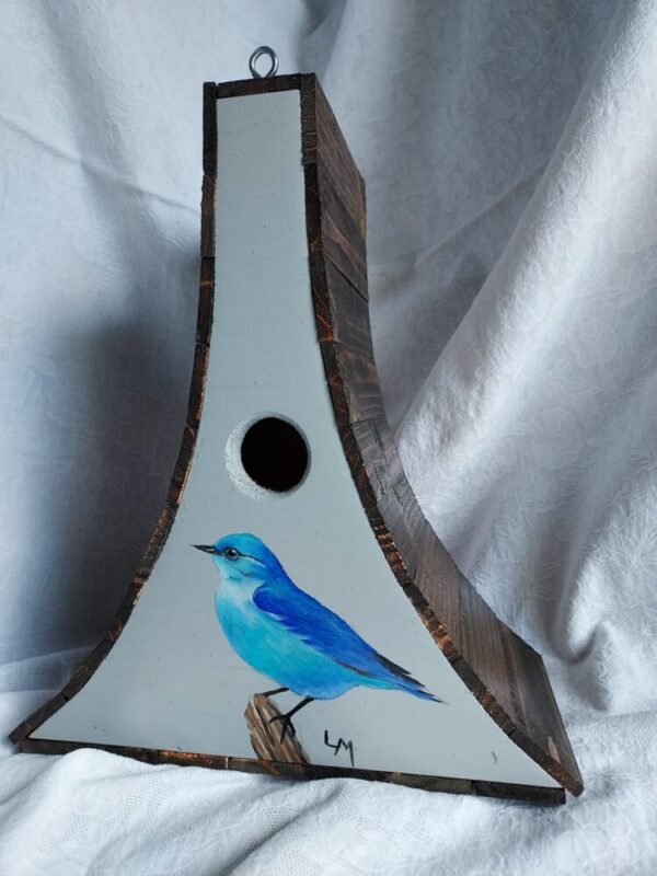 Birdhouse with a blue Mountain bluebird painted on it